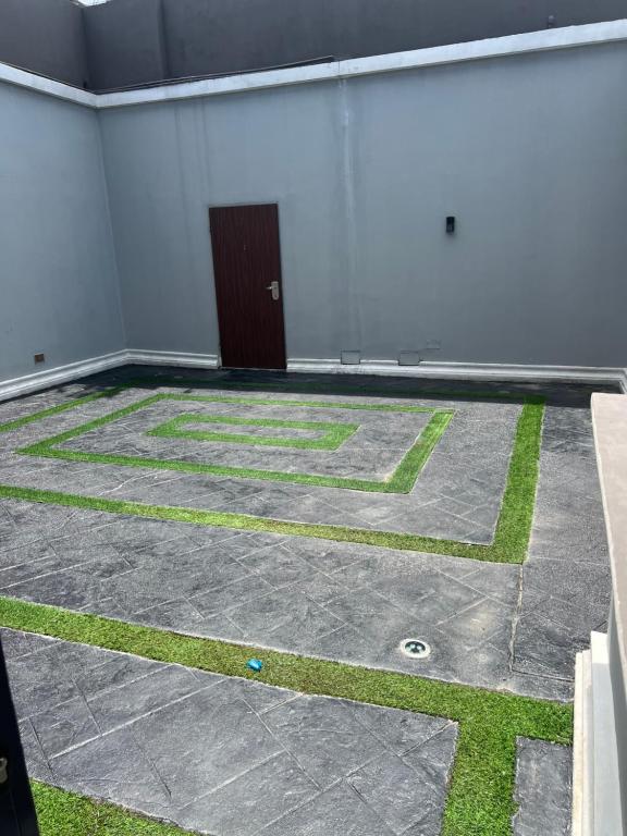 an empty room with a door and grass on the floor at 2 Bedroom Penthouse, Victoria Island Lagos in Maroko