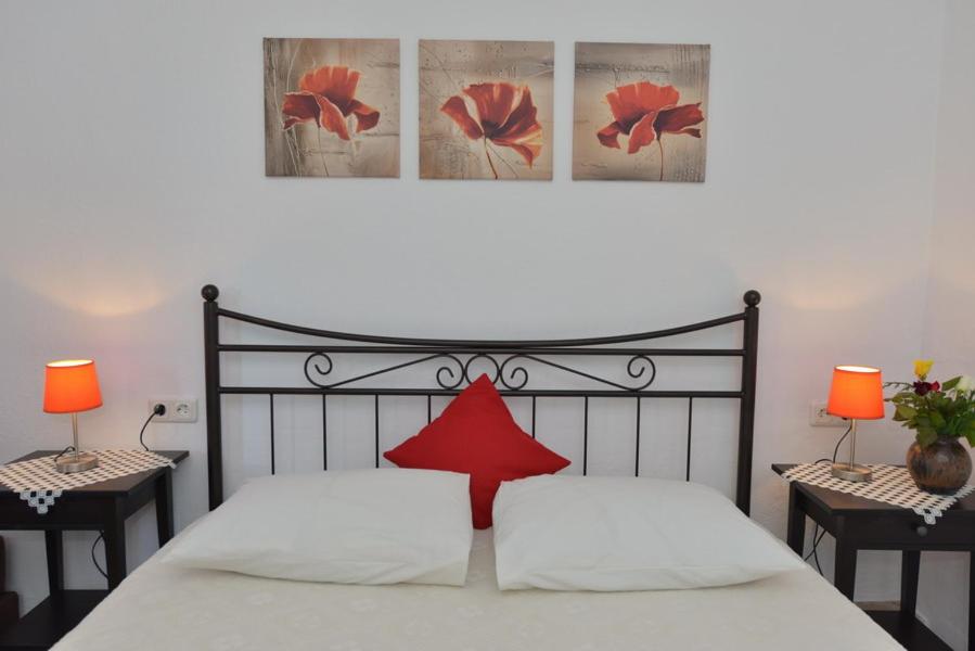 a bedroom with a bed with a red star on it at Haus Katerina in Vourvourou