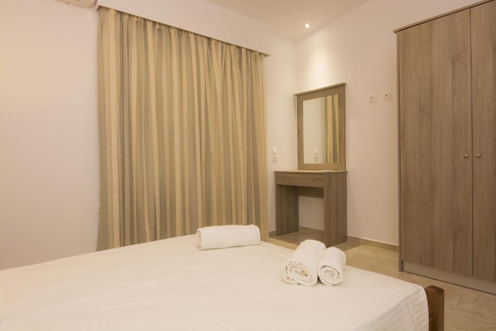 a bedroom with a bed with two towels on it at Villa Giorgos in Kefalos