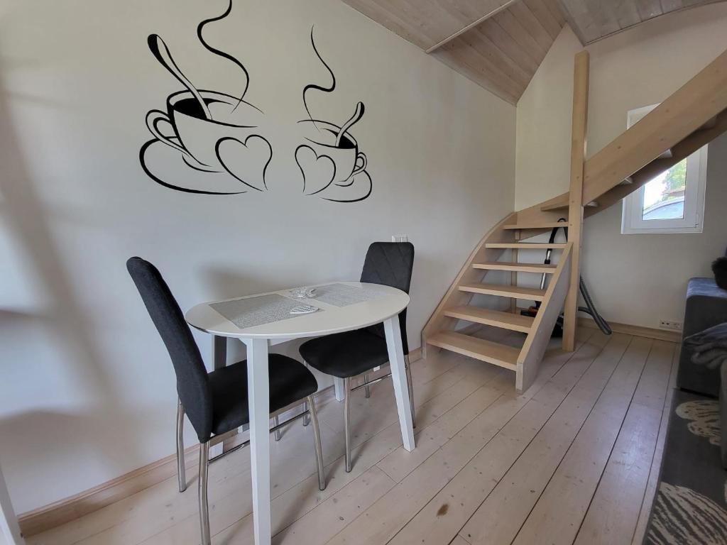 a table and chairs in a room with a staircase at Kaldeni majutus in Are