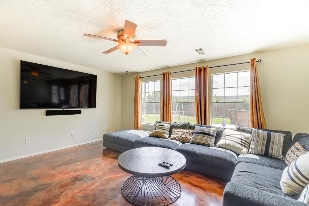 a living room with a couch and a ceiling fan at Houston Vacation Rental 14 Mi to Downtown in Houston