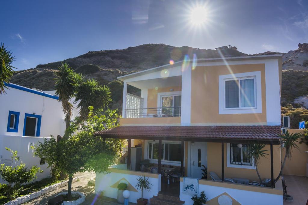 a house with a mountain in the background at Villa Giorgos in Kefalos