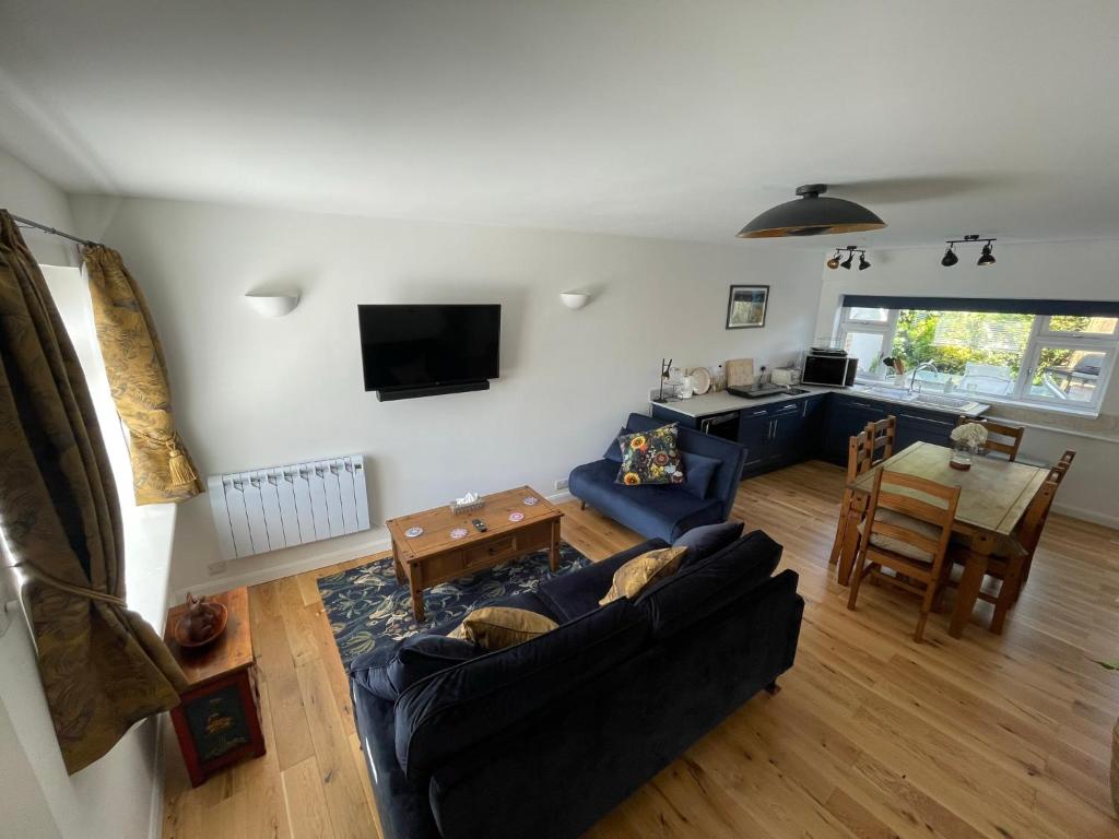 a living room with a couch and a table at Close to sea and South Downs national park - Sompting in Sompting