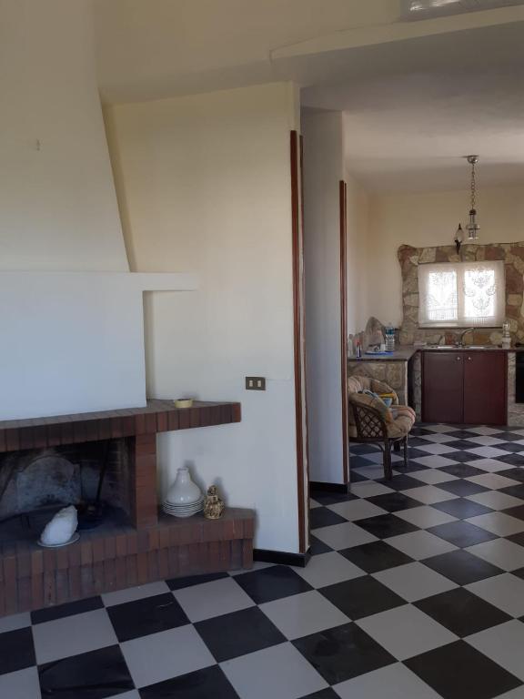 - un salon avec une cheminée et un sol en damier dans l'établissement Casa vacanze zina, à Altavilla Milicia