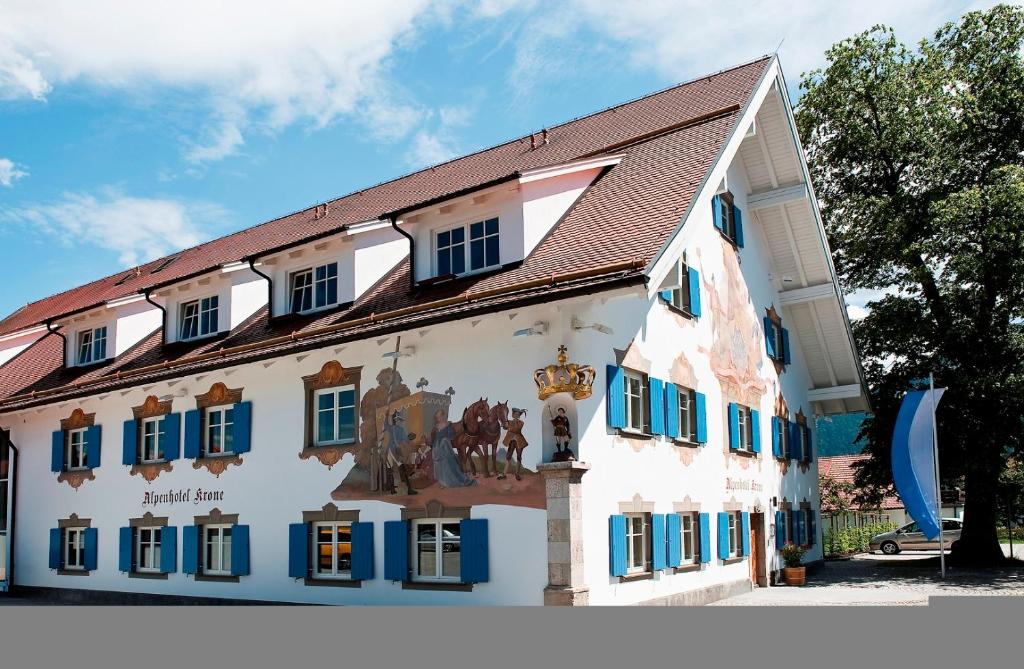 a building with a mural on the side of it at Alpenhotel Krone in Pfronten