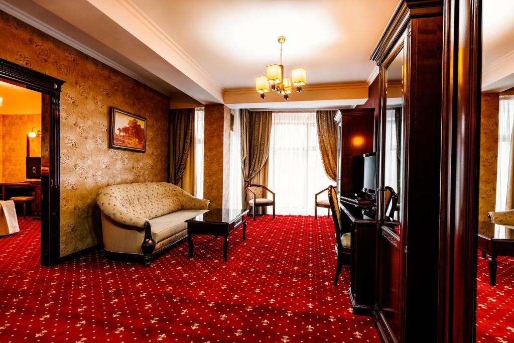 a hotel room with a bed and a red carpet at President Resort Hotel in Chişinău