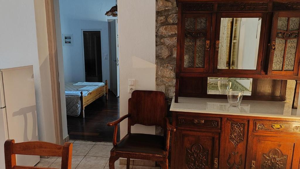 a room with a desk and a chair and a bedroom at TRADITIONAL HOUSE ALEPIS IN AREOPOLIS in Areopolis