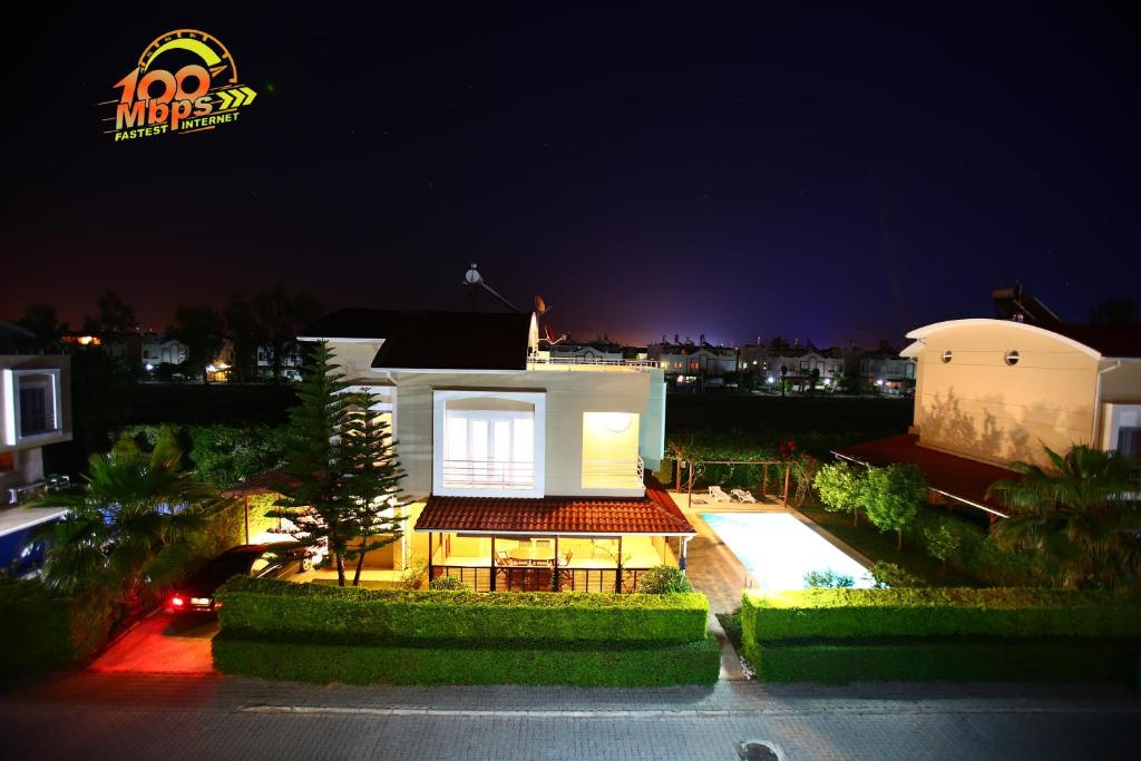 a large white house at night with its lights on at Paradise Town Villa Royal 100 MBPS free wifi in Belek