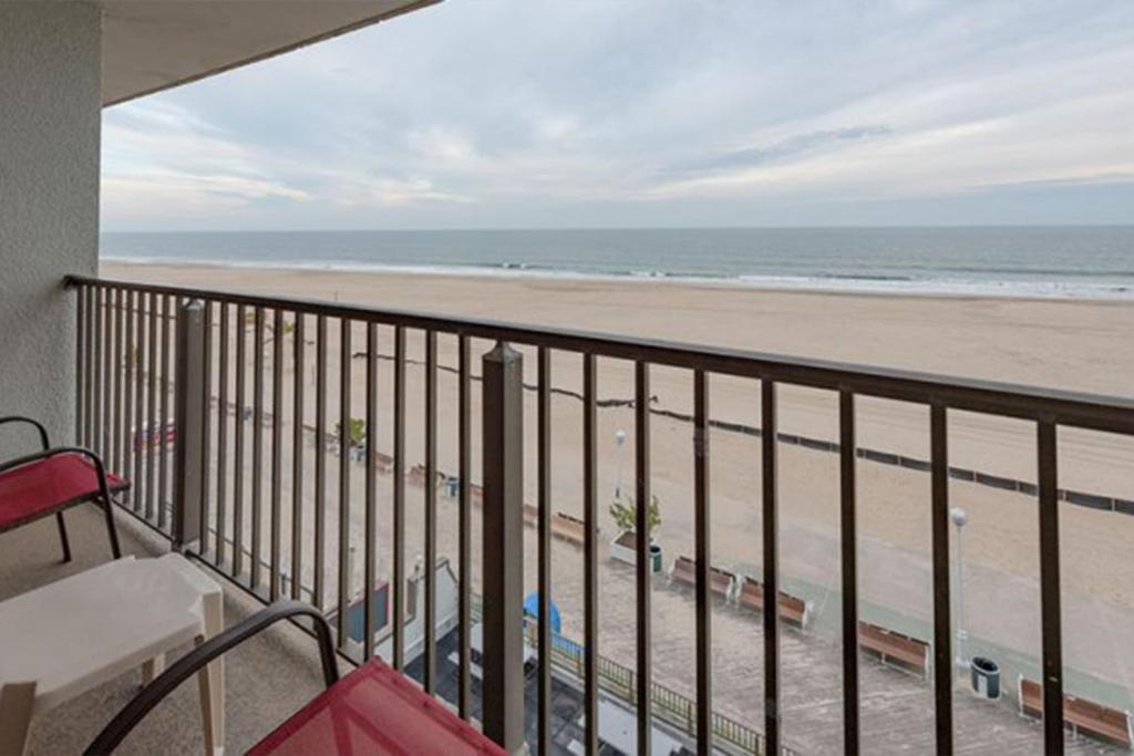 a balcony with a view of the beach at Studio w Balcony and Ocean View - Boardwalk One - 203 in Ocean City