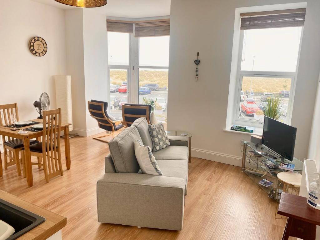 a living room with a couch and a table at Bellaview Apartment Barmouth in Barmouth