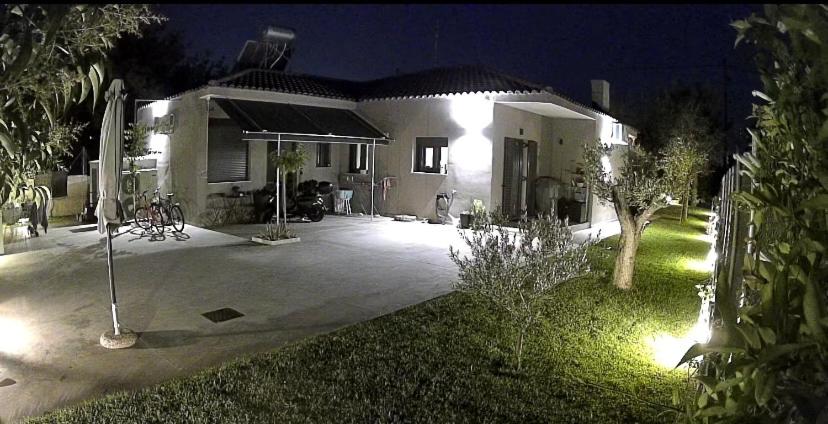 a house at night with a driveway and a yard at no.21house studio apartment in Rio