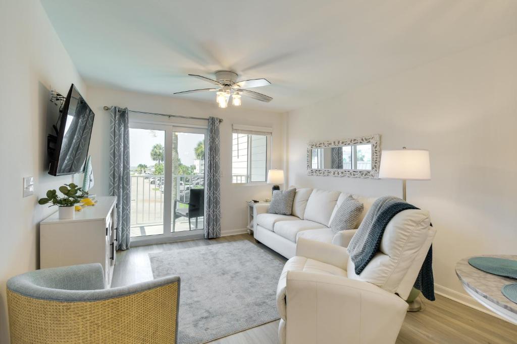 a living room with a white couch and a tv at Gulf Shores Condo with Private Balcony on the Beach! in Gulf Highlands