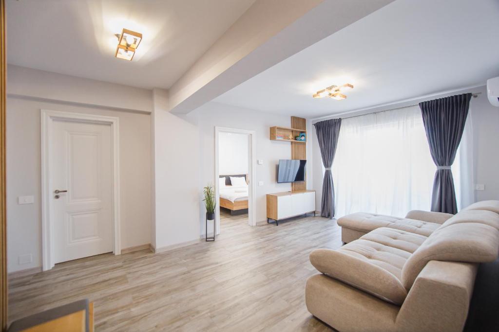 ein Wohnzimmer mit Sofa und ein Schlafzimmer in der Unterkunft Creamy Wood Haven in Oradea