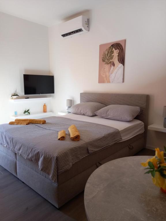 a bedroom with a large bed with towels on it at Dani in Zadar