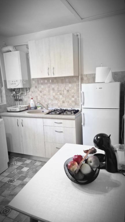 a kitchen with a bowl of fruit on a counter at Ambasador in Sibiu