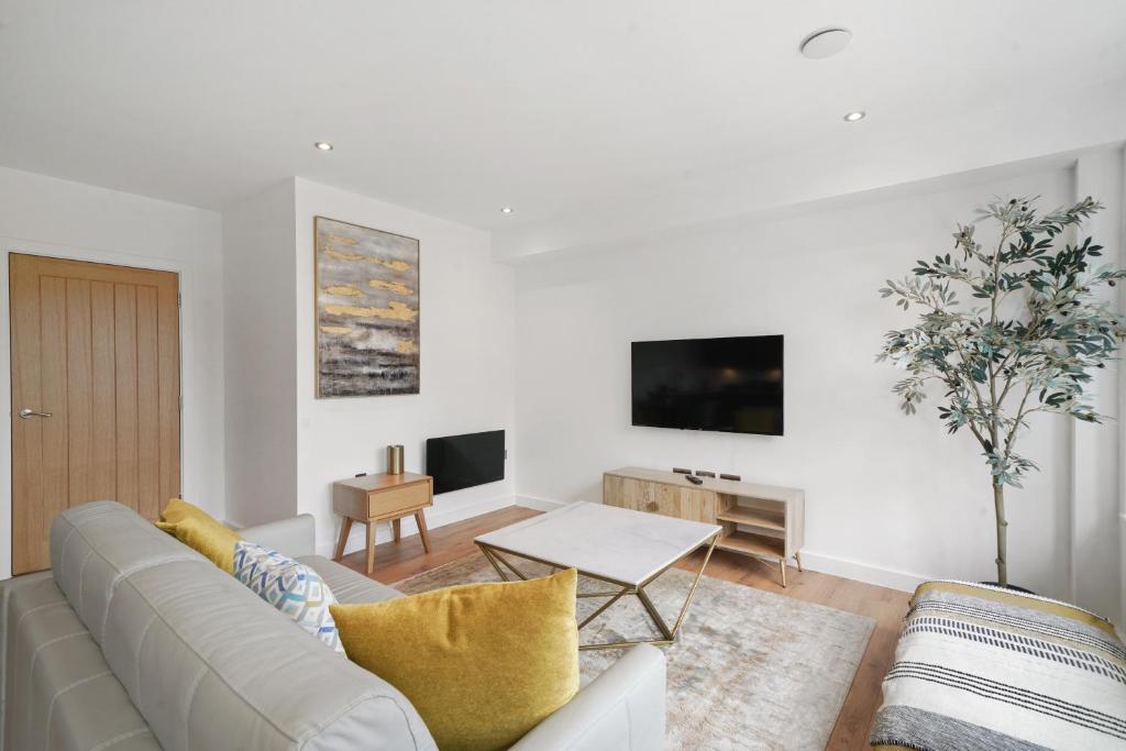 a white living room with a couch and a table at Modern Apartments in Vibrant Ramsgate in Kent
