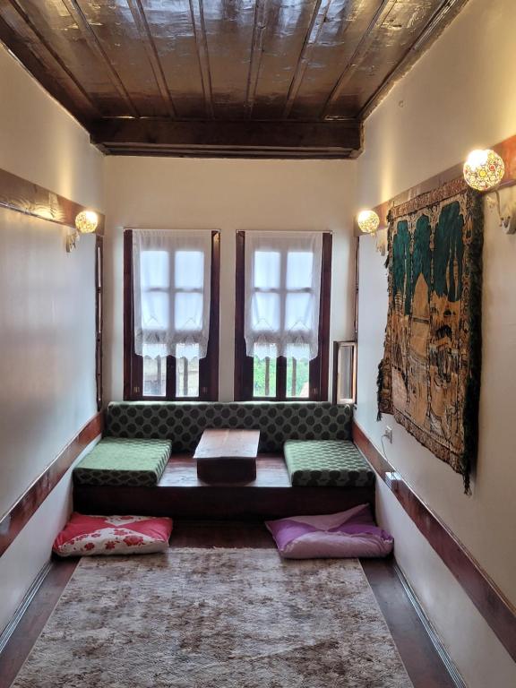 a living room with a couch and windows at Fatma Hanım Konağı butik Otel in Safranbolu