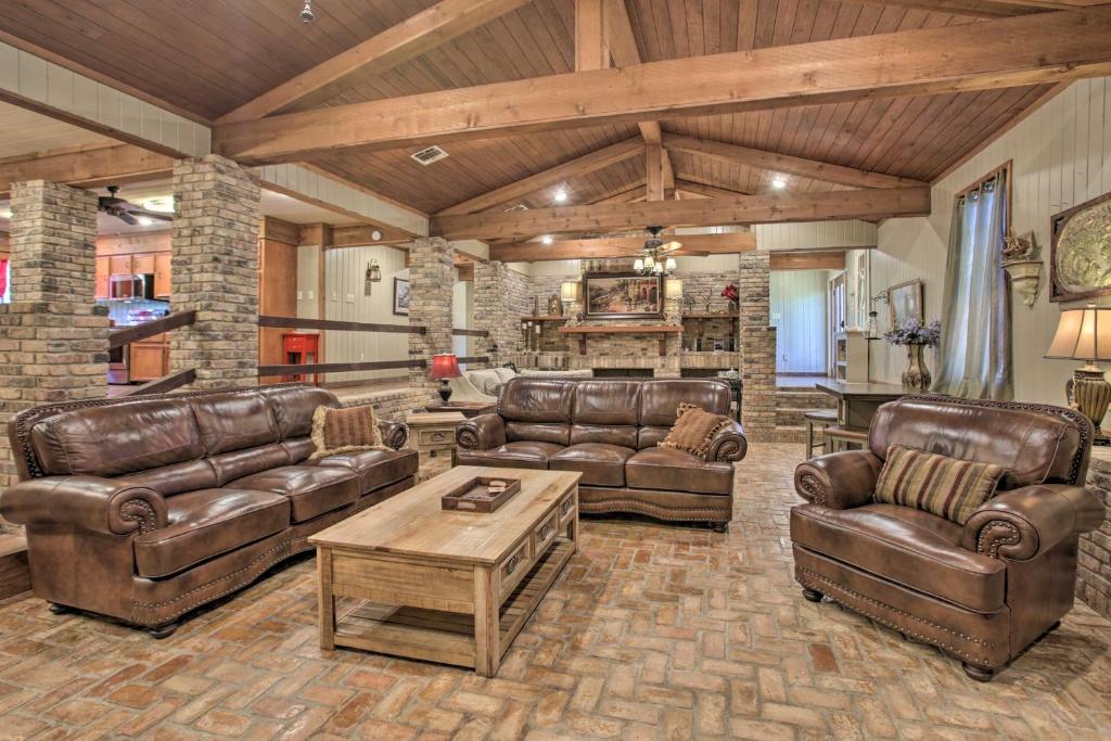 a large living room with leather couches and a table at Dularge Grand Villa - Steps to Marina and Fishing! in Theriot
