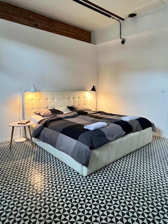 a bedroom with a large bed in a room at SPOKO Hostel in Gdańsk