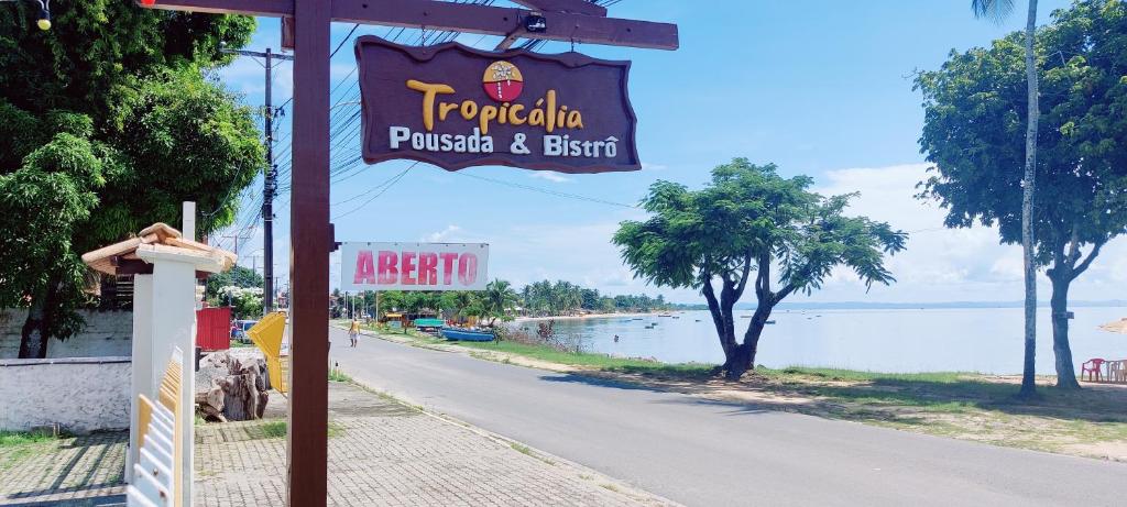 a sign for a restaurant on the side of a street at Pousada Tropicalia in Itaparica