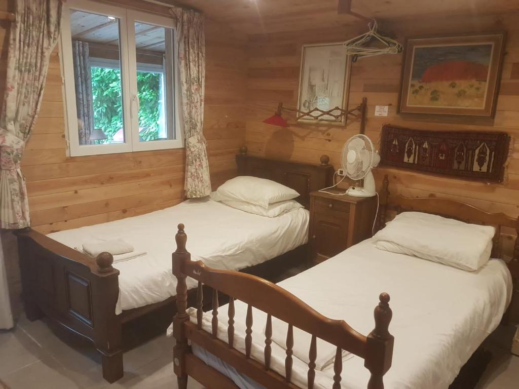 a bedroom with two beds and a window at Holiday Chalet 2 Set in Country side in Bouteilles-Saint-Sébastien