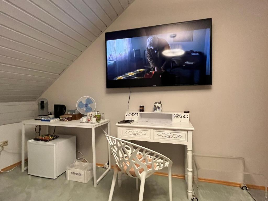a living room with a tv hanging on the wall at Zimmer zum Wohlfühlen in Eching