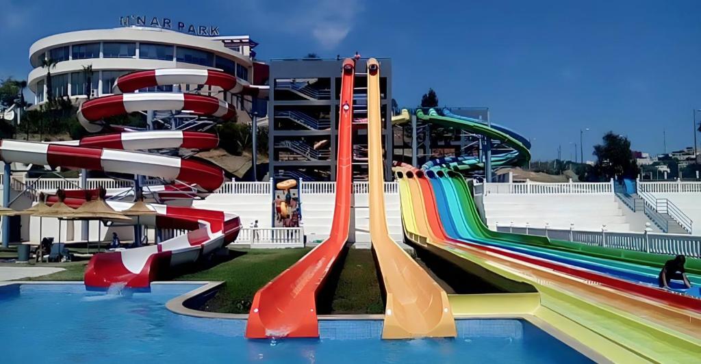 a water park with a water slide in front of a building at Appartement En Bord de Mer in Tangier