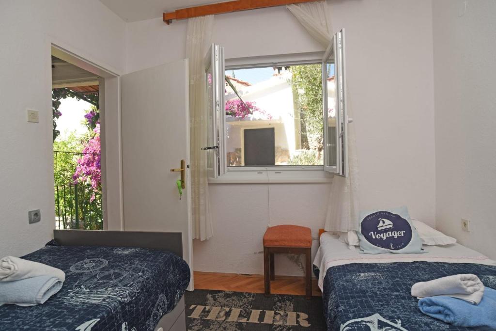 ein kleines Zimmer mit 2 Betten und einem Fenster in der Unterkunft Veronika in Drvenik Veli