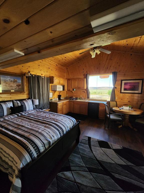 a bedroom with a bed and a table in a room at Grandpa's Cabin in Apple Valley