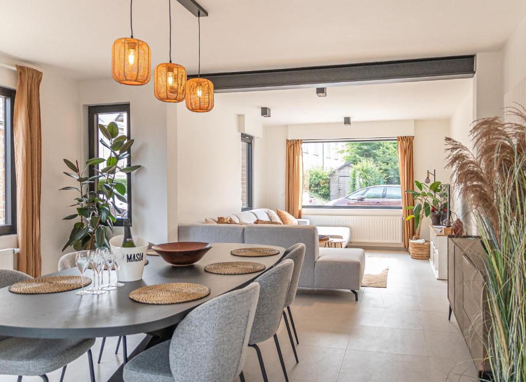 a living room with a table and chairs and a couch at Villa Dianga (De Haan) in De Haan