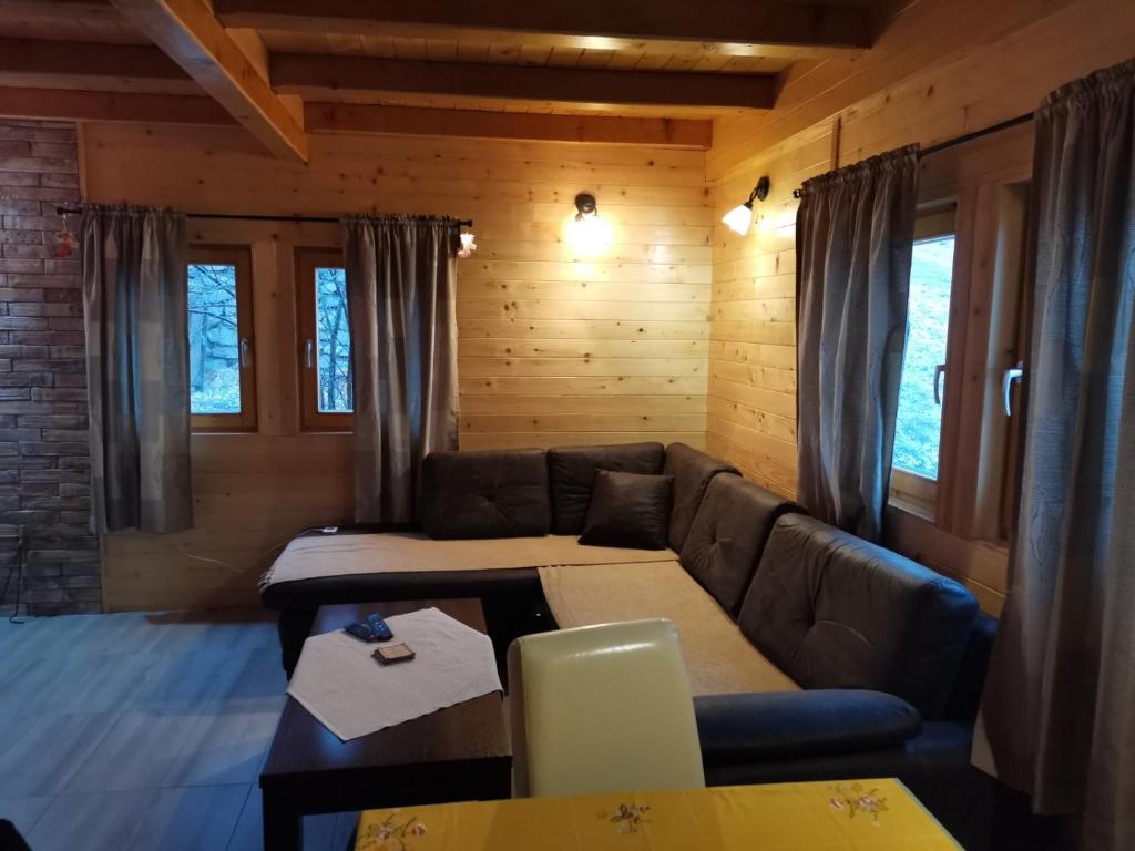 a living room with a couch and a table at Brvnare Libero TARA in Sekulić 