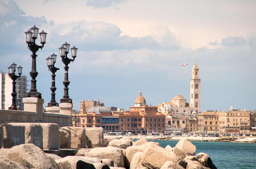 a city with street lights and buildings in the water at ARIEL HOUSE in Bari