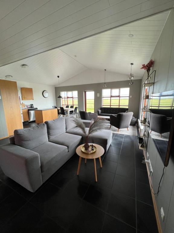 ein Wohnzimmer mit einem Sofa und einem Tisch in der Unterkunft Fíflholt in Hvolsvöllur