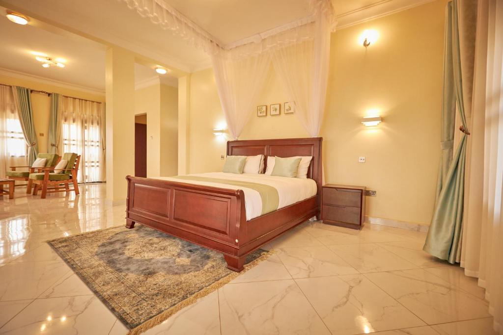 a bedroom with a bed and a living room at The Forest House - Kawuku-Bunga in Kampala