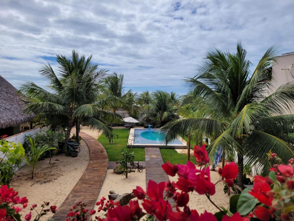 a view of a resort with a pool and palm trees at Condomínio Shalom Beach in Canoa Quebrada