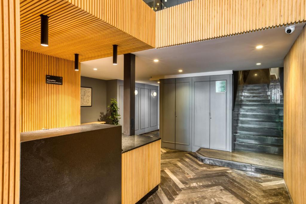A compact reception lobby with elevators and a staircase.