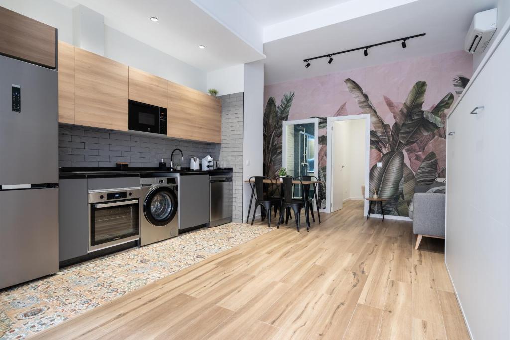 an open kitchen and dining room with a dining table at Beach Apartments Valencia in Valencia