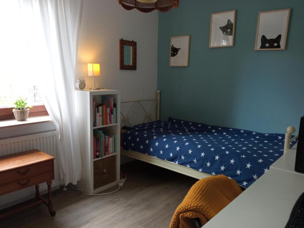 a bedroom with a bed and a book shelf at Gemütliches Zimmer in Einfamilienhaus in Rehlingen