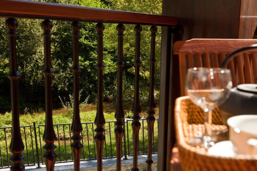 a balcony with a table and a glass of wine at Segotegi Etxea in Orio