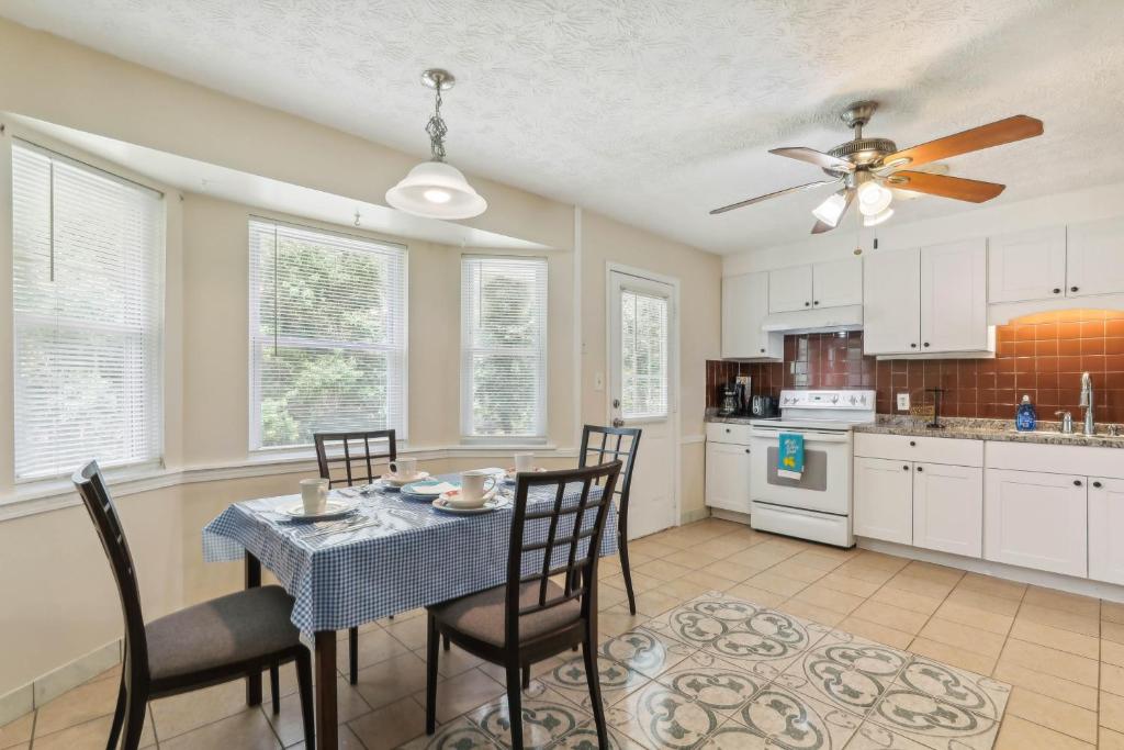 een keuken met een tafel met stoelen en een plafondventilator bij Snellville Getaway about 8 Mi to Stone Mountain Park! in Snellville
