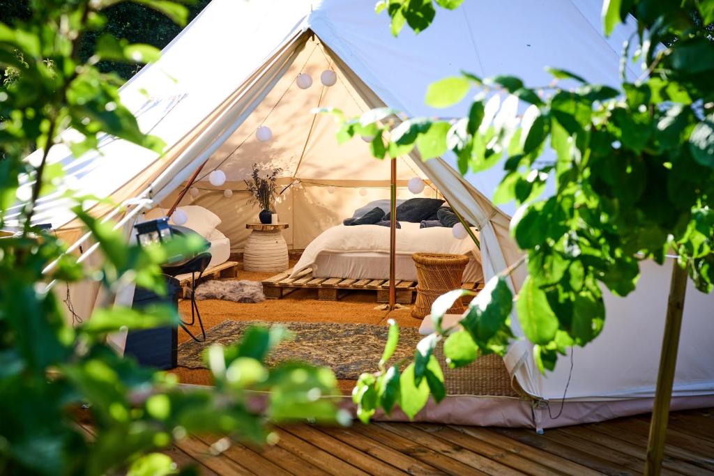 a bedroom in a tent with a bed in it at Hesselgaard Glamping in Dalby