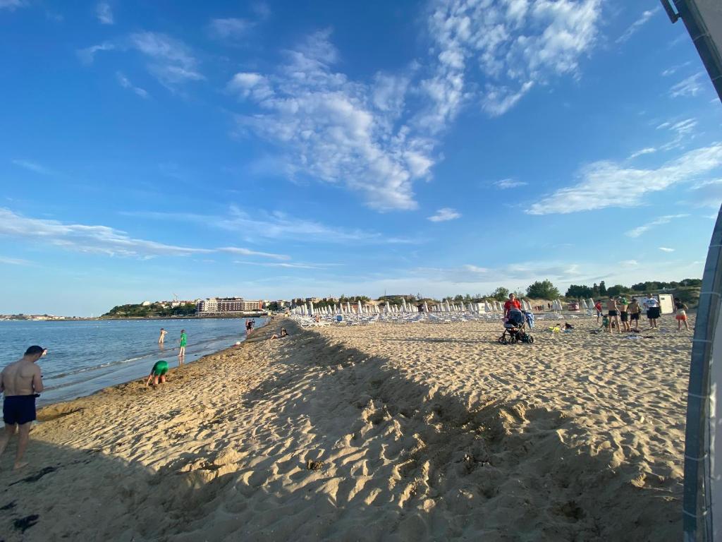 a group of people standing on a beach at PARADISO 'В' 403 Fancy Studio Nessebar in Nesebar