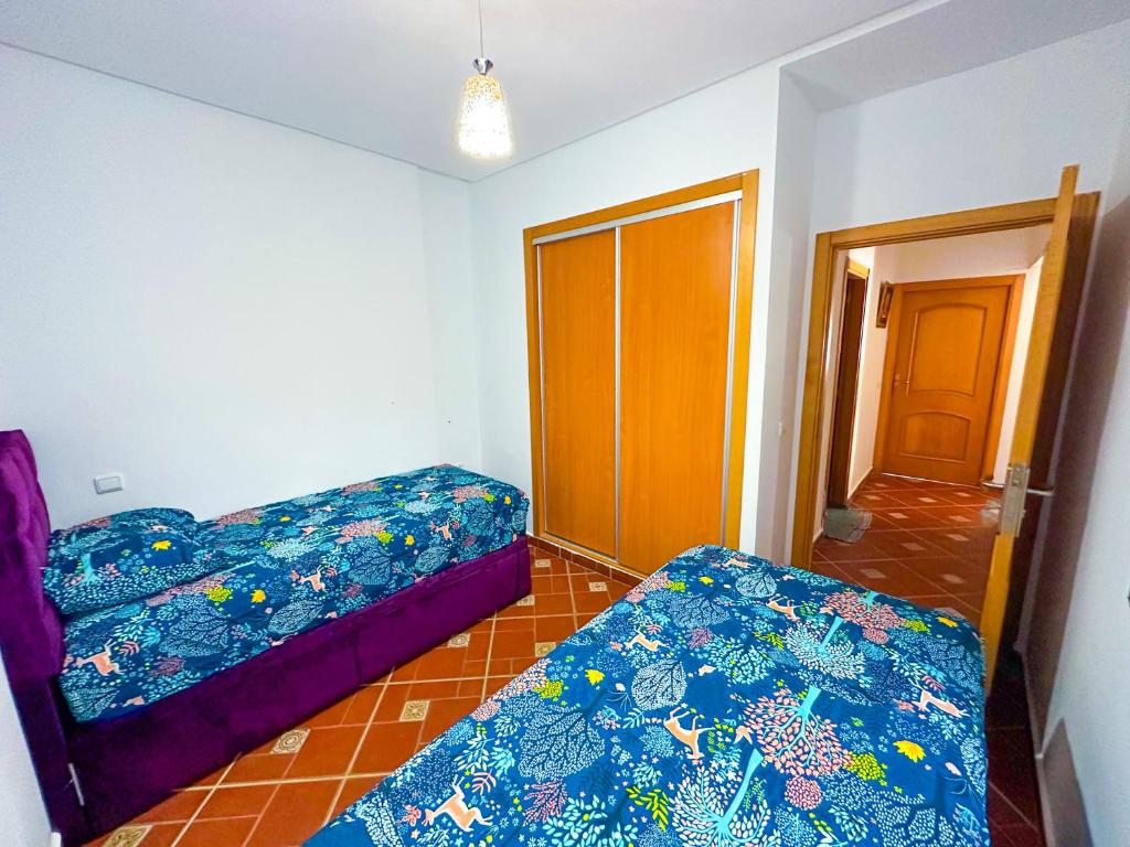 Postel nebo postele na pokoji v ubytování Residence Al Kasaba - Spacious apartment with swimming pool and direct access to sea