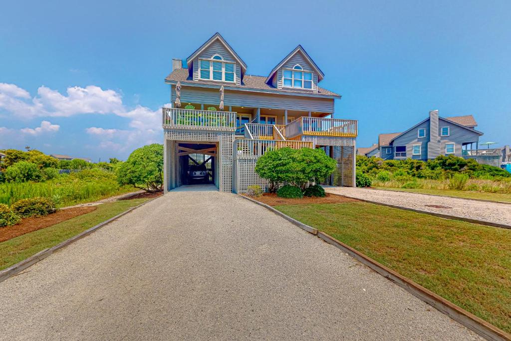 a large house with a driveway in front of it at Compass Rose in Topsail Beach