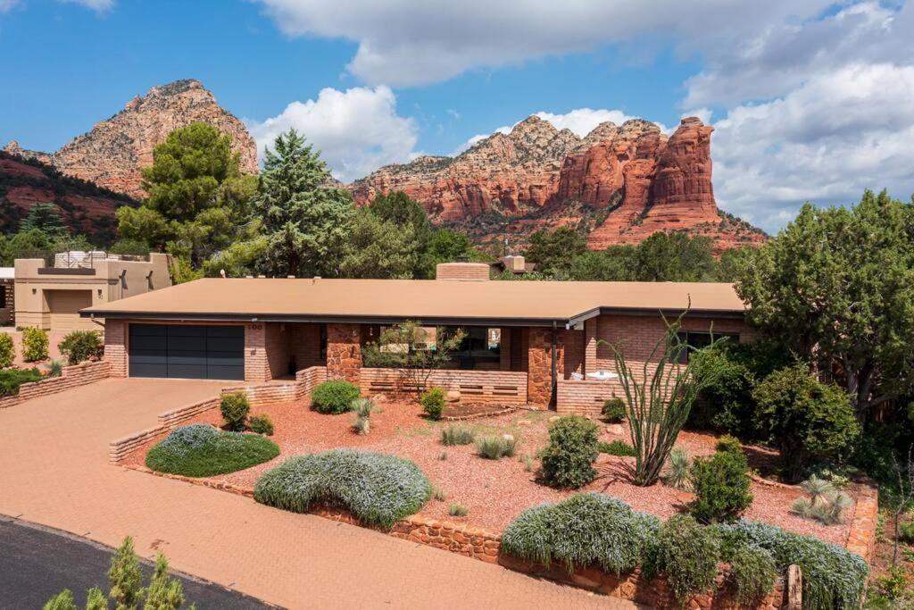 a house with a landscaping in front of a mountain at Jacuzzi, Walk to Trails, Stunning Views, Mid-Century Modern,Pool in Sedona