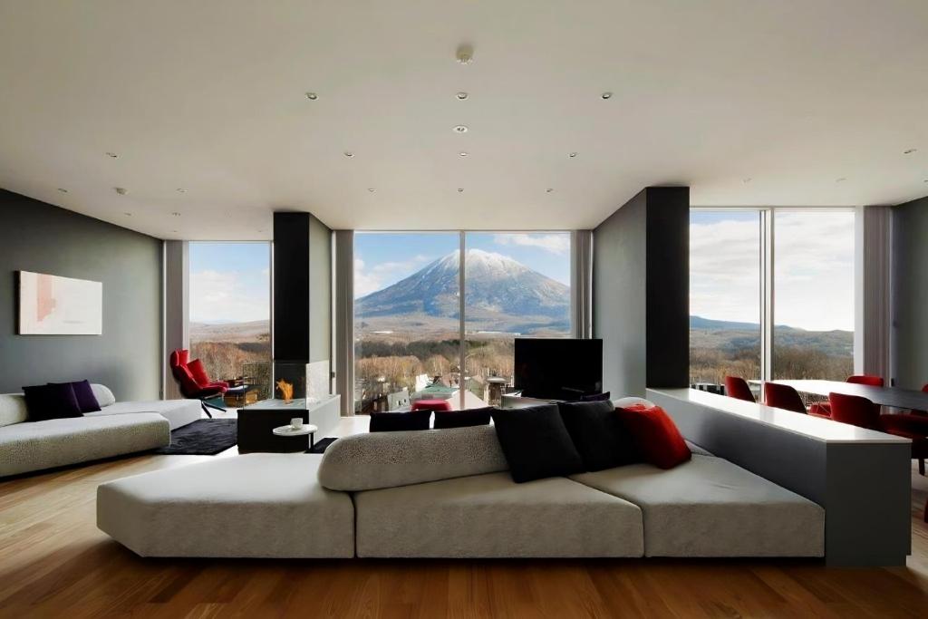 a living room with a couch and a mountain view at Terrazze in Kutchan