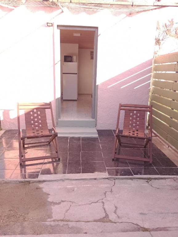 two chairs sitting on a porch with a refrigerator at Tákate DoS in La Paloma