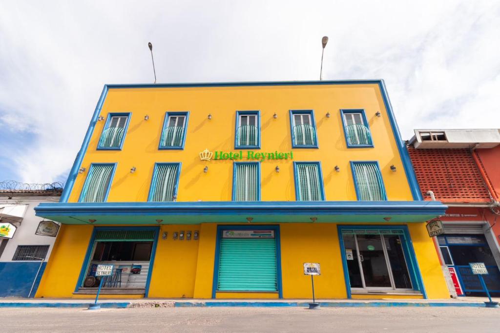 a yellow building with a sign that reads hotel headquarters at Hotel Reynieri in Comayagüela