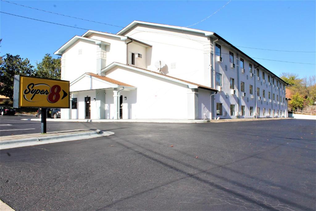 a large white building with a sign in front of it at Super 8 by Wyndham Greensboro/Coliseum/Conv. in Greensboro