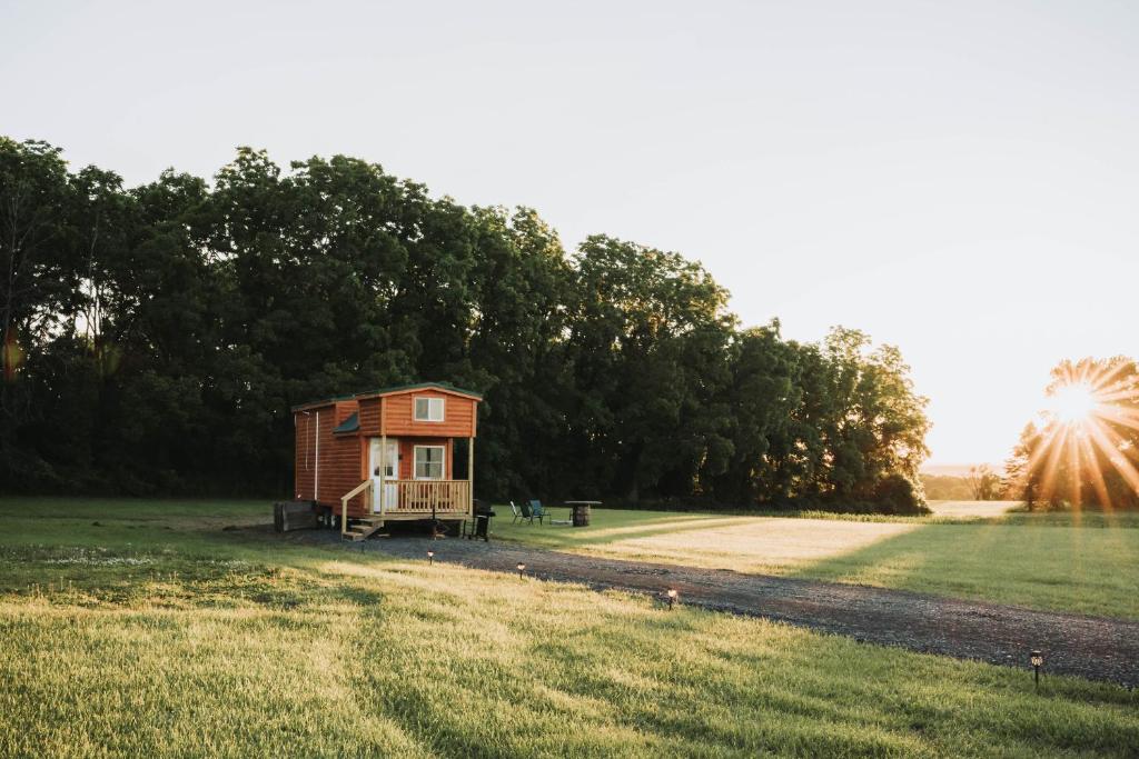 a tiny house in the middle of a field at Hollow Hills Tiny Home in Penn Yan